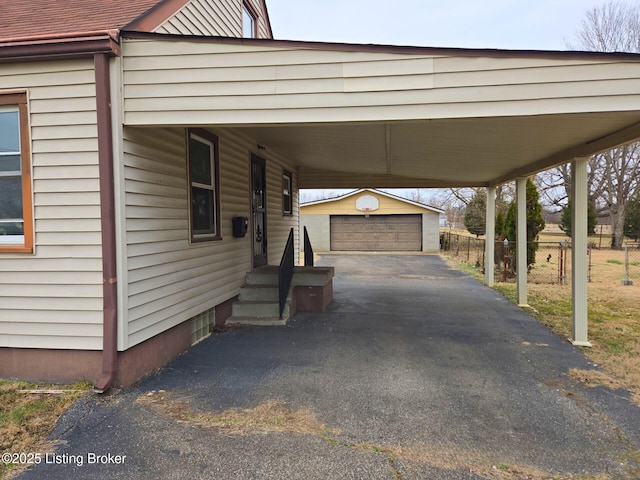 view of parking / parking lot featuring a garage and a carport