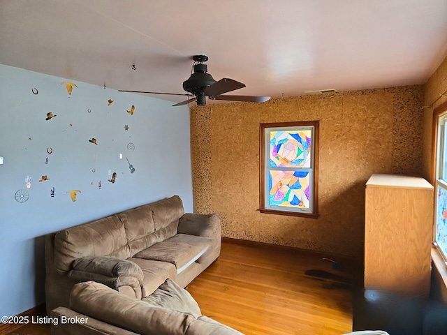 living room with ceiling fan and wood-type flooring