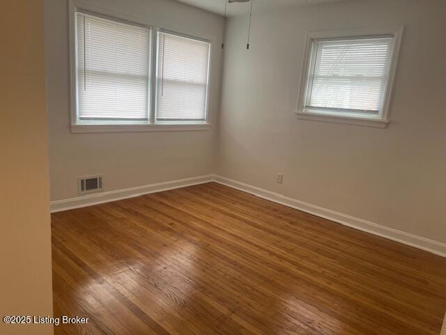 spare room with hardwood / wood-style floors