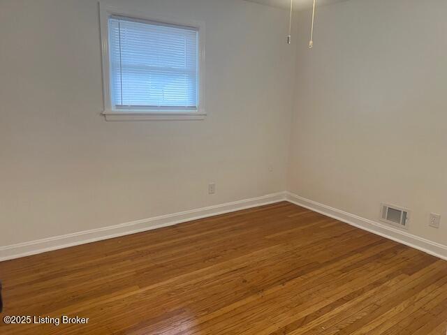 empty room featuring hardwood / wood-style floors