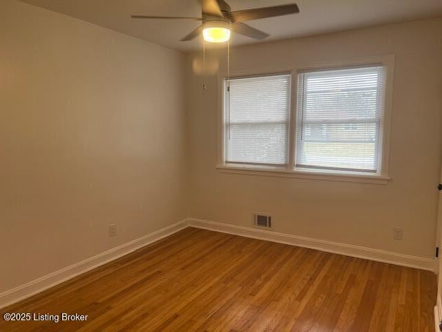 spare room featuring ceiling fan and light hardwood / wood-style flooring