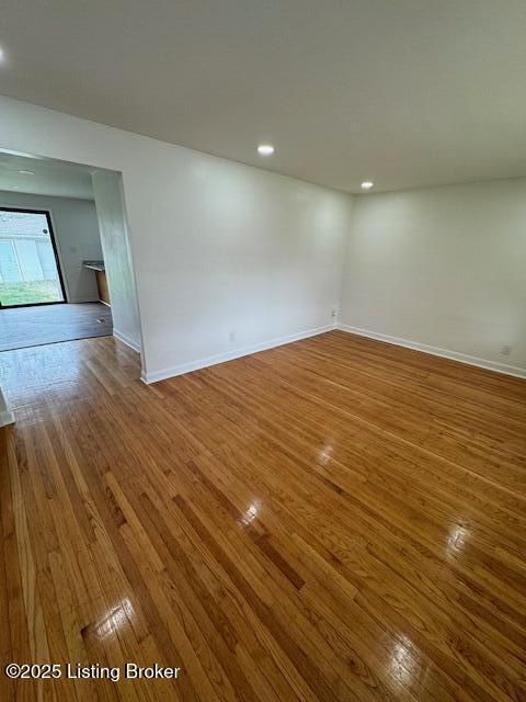 spare room with hardwood / wood-style floors