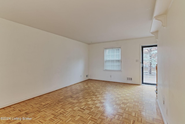 spare room with light parquet floors