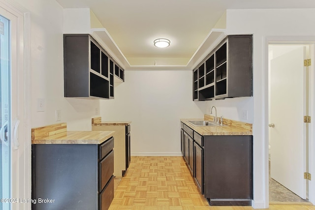 kitchen featuring light parquet floors and sink