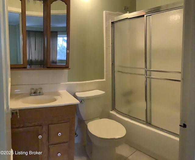 full bathroom with enclosed tub / shower combo, vanity, and toilet