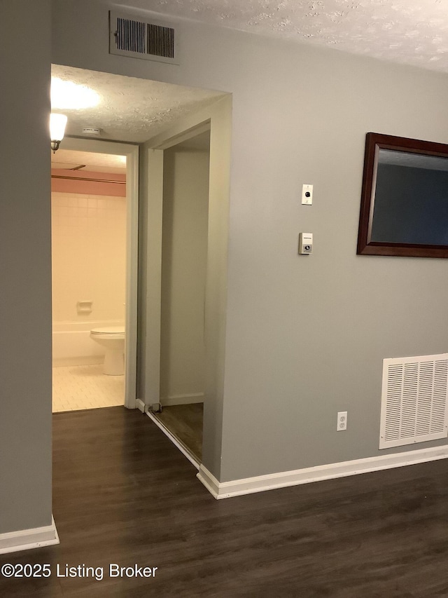 hallway featuring dark wood-type flooring