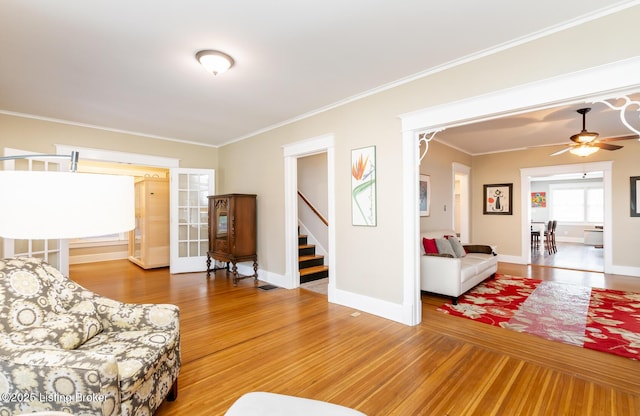 living room featuring crown molding and hardwood / wood-style floors