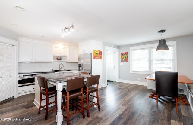 dining space with dark wood-type flooring and sink