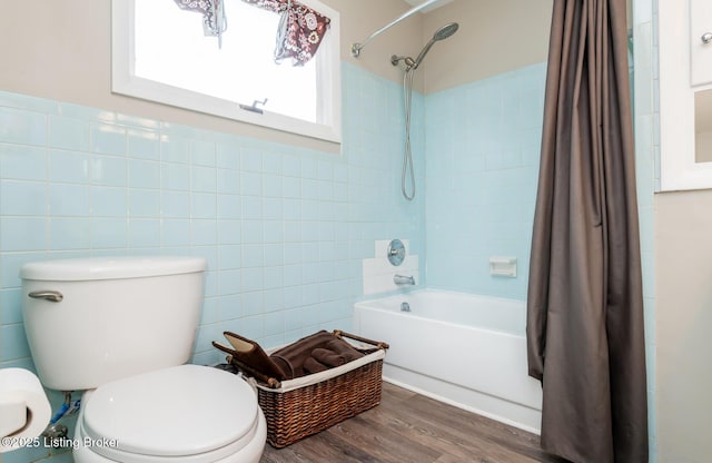 bathroom with tile walls, hardwood / wood-style flooring, toilet, and shower / bath combo with shower curtain