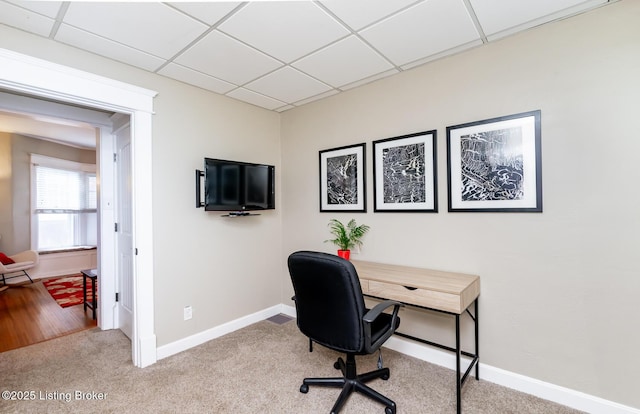 carpeted office with a drop ceiling