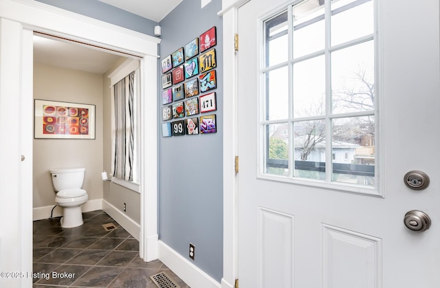 interior space featuring tile patterned floors and toilet