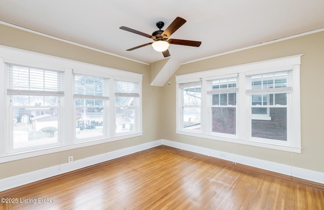 empty room with crown molding, ceiling fan, and hardwood / wood-style floors