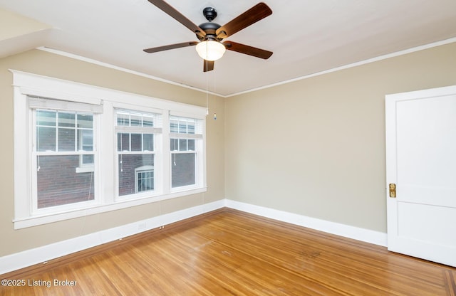 spare room with crown molding, ceiling fan, and hardwood / wood-style floors