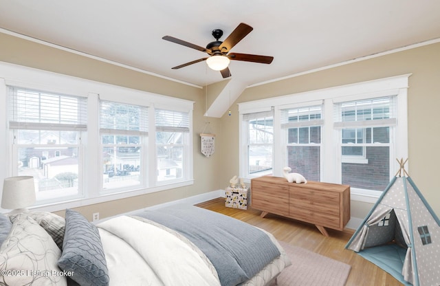 bedroom with ornamental molding, light hardwood / wood-style floors, and ceiling fan