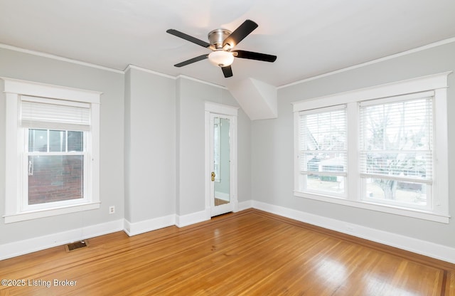 unfurnished room featuring hardwood / wood-style flooring, crown molding, and ceiling fan