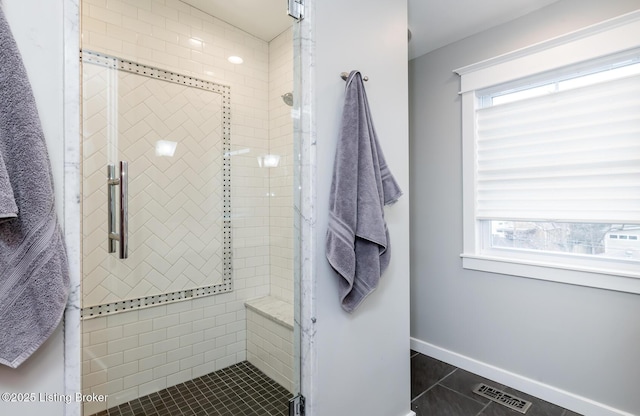 bathroom with tile patterned flooring and a shower with door