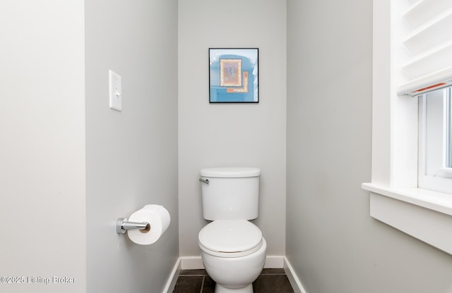 bathroom featuring toilet and tile patterned flooring