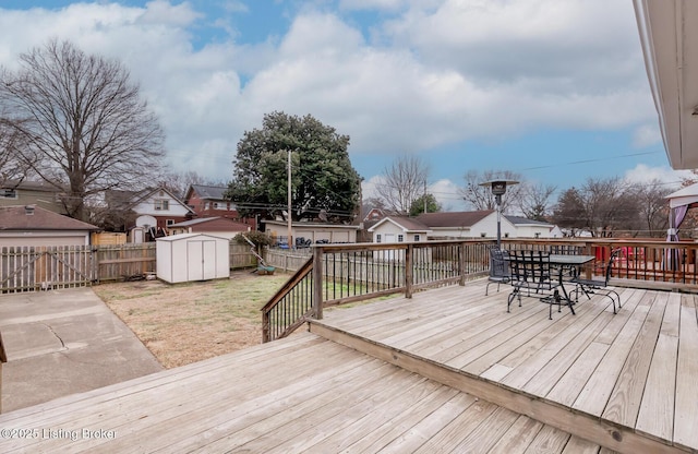 wooden deck featuring a shed