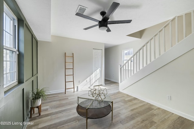 interior space featuring ceiling fan, light hardwood / wood-style flooring, and a textured ceiling