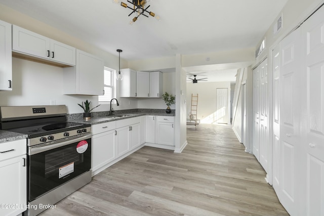 kitchen featuring ceiling fan, decorative light fixtures, stainless steel range with electric cooktop, and white cabinets