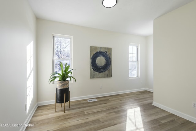 spare room with light hardwood / wood-style flooring