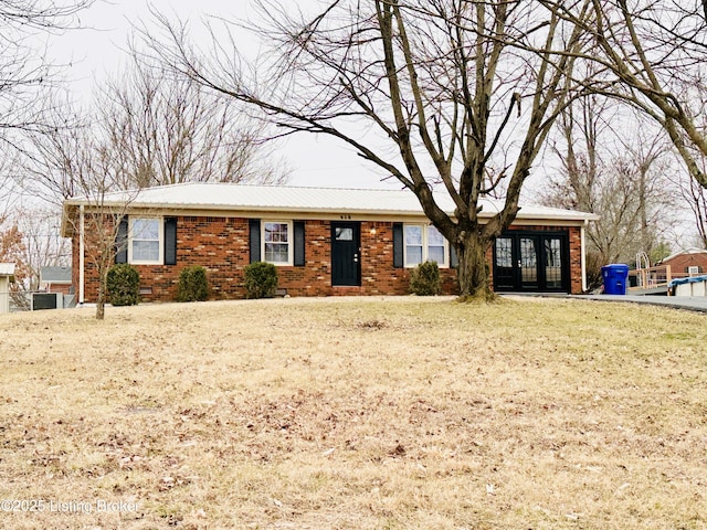 single story home with a front lawn and french doors