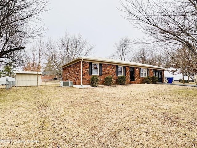 view of front facade with central AC unit and a front yard