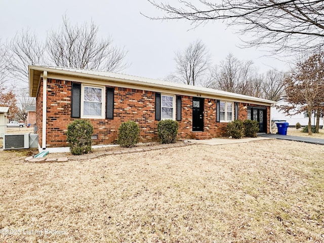 single story home featuring central AC unit