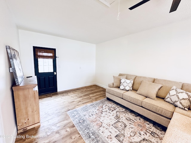 living room featuring hardwood / wood-style flooring and ceiling fan