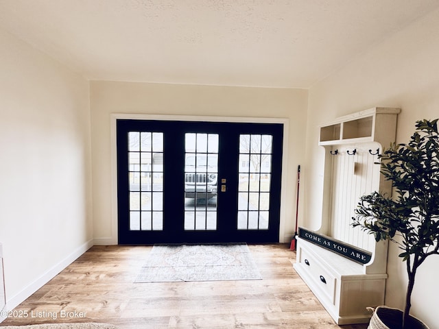 mudroom featuring light hardwood / wood-style flooring, french doors, and a healthy amount of sunlight