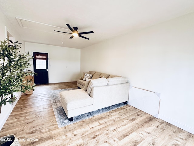 living room with wood-type flooring and ceiling fan