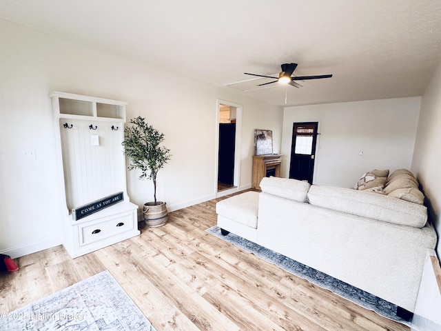 living room with ceiling fan and light hardwood / wood-style flooring