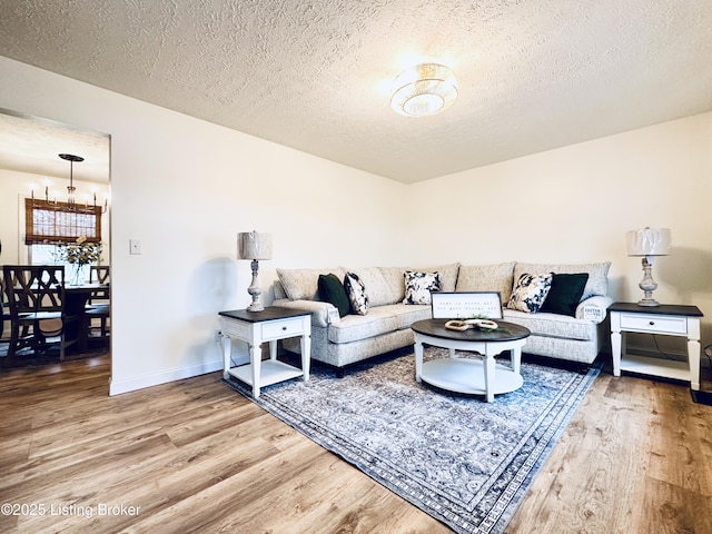 living room featuring wood-type flooring and a textured ceiling