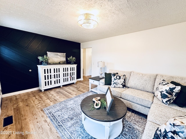 living room featuring hardwood / wood-style flooring and a textured ceiling