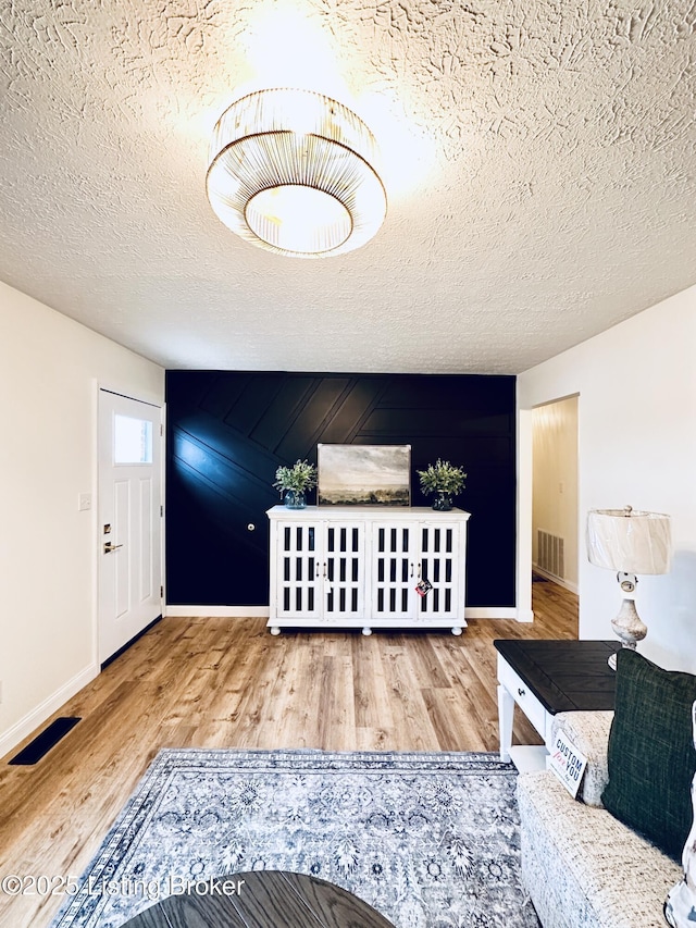 living room with hardwood / wood-style floors and a textured ceiling