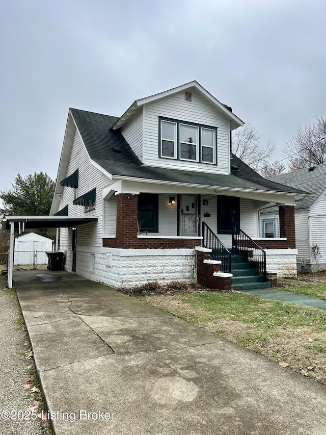 view of front of property featuring a carport and covered porch