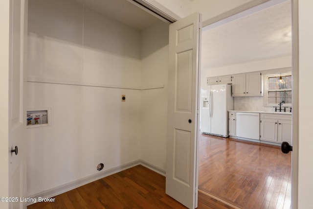 laundry area with a sink, laundry area, dark wood-style flooring, and hookup for a washing machine