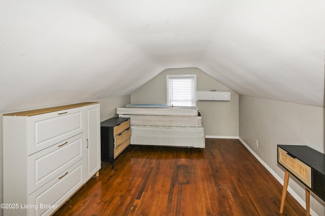 unfurnished bedroom with dark wood-type flooring, lofted ceiling, and a wall mounted AC