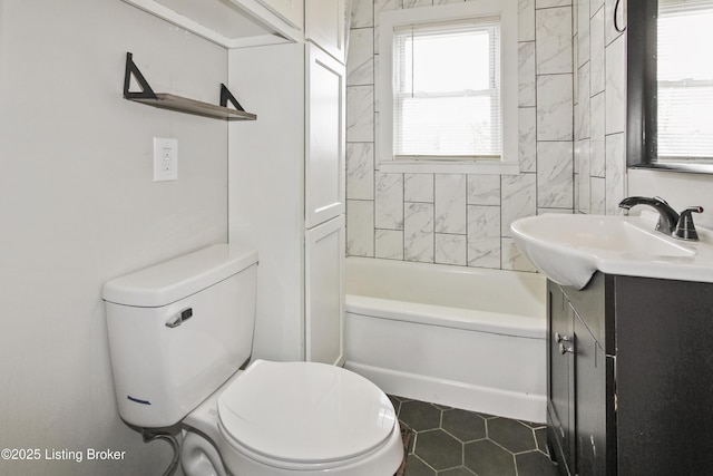 bathroom with vanity, tile patterned floors, toilet, and a healthy amount of sunlight