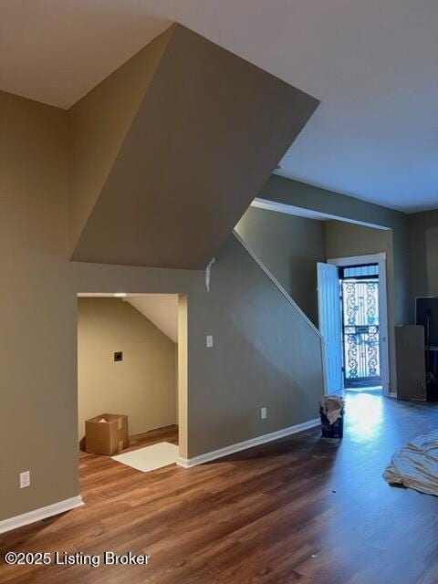 bonus room with wood finished floors and baseboards