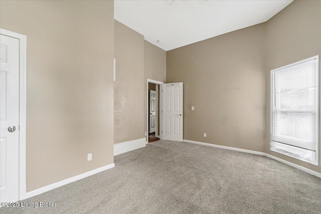 2715 W Market St, Louisville, KY 40212 - empty room with carpet and high vaulted ceiling