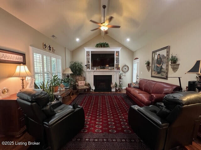 living room featuring vaulted ceiling with beams and ceiling fan