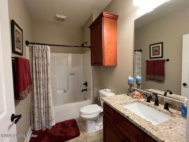 full bathroom featuring vanity, tile patterned floors, toilet, and shower / bath combo with shower curtain