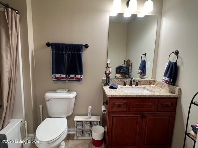 full bathroom featuring vanity, toilet, and shower / tub combo with curtain