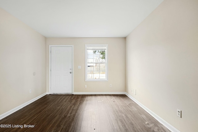 unfurnished room with dark hardwood / wood-style flooring