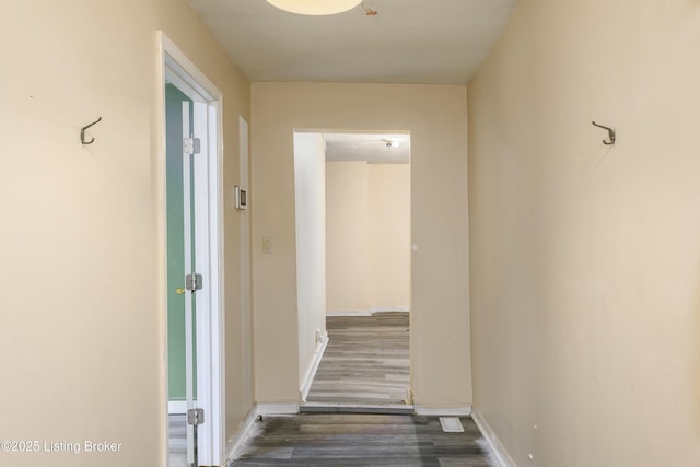 corridor with dark wood-type flooring