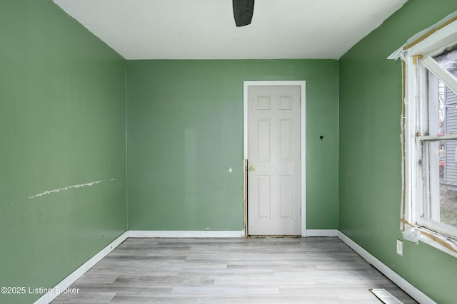 unfurnished room featuring ceiling fan, a healthy amount of sunlight, and light hardwood / wood-style flooring