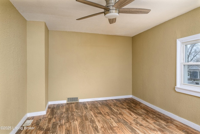 empty room with hardwood / wood-style flooring and ceiling fan