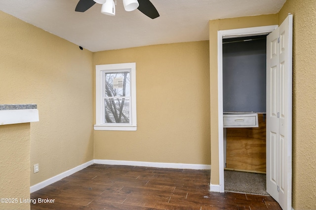 unfurnished bedroom featuring ceiling fan and dark hardwood / wood-style flooring