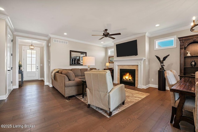 living room featuring dark wood-style floors, visible vents, and a healthy amount of sunlight